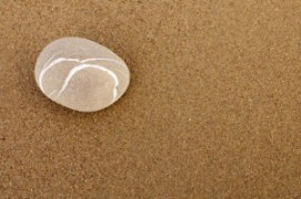 Zen rock on beach sand